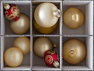 Christmas balls sorted into a cardboard box with dividers