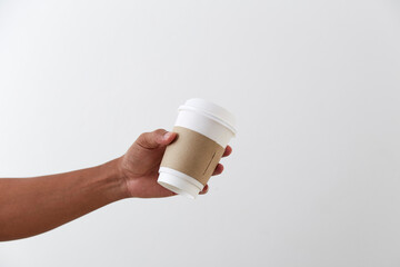 Mockup of male hand holding a coffee paper cup