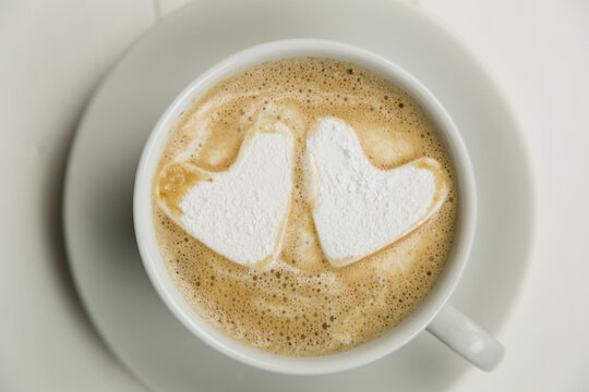 Overhead shot of two hearts in hot chocolate