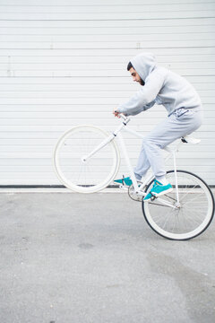 Cyclist doing trick on fixie bike.