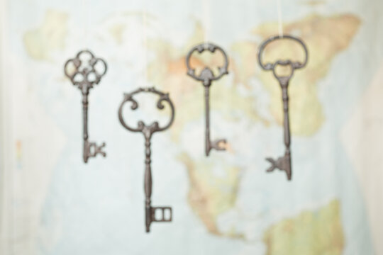 Vintage skeleton keys hanging in front of world map