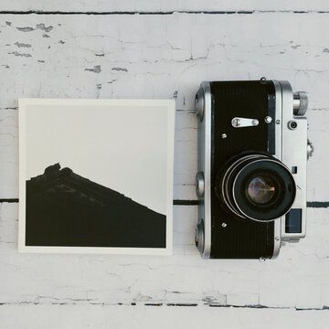 Printed black and white cat image close to old russian camera