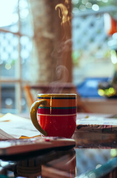 Multi-colored coffee mug with swirly steam rising out of it
