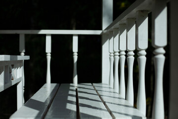 Balusters on the veranda. The railings are white. 