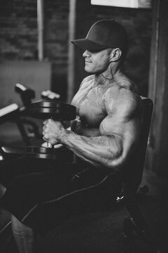 Male bodybuilder lifting weights in gym