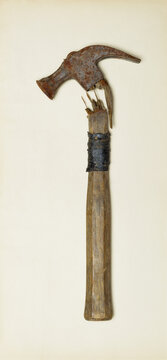 Broken claw hammer on old paper