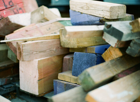 Close up of a pile of scrap colored wood and lumber