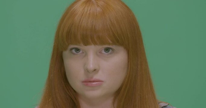Studio, slow motion, an exasperated young woman against a green screen, London, UK