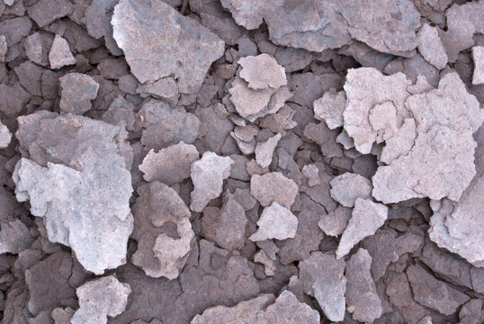 closeup macro of gray rock fractured into pieces drying after an ice storm
