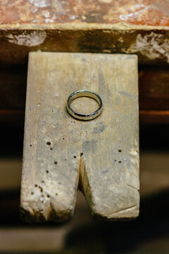 14K gold wedding band on a jeweler's bench