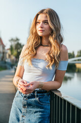 Portrait of beautiful young woman at sunset