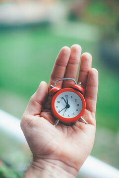 Man holding alarm clock