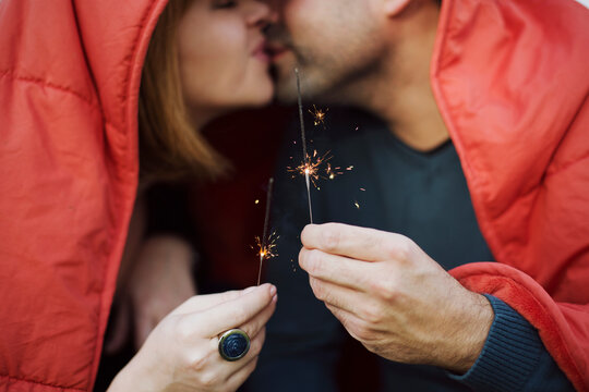 Young couple holding sparklers