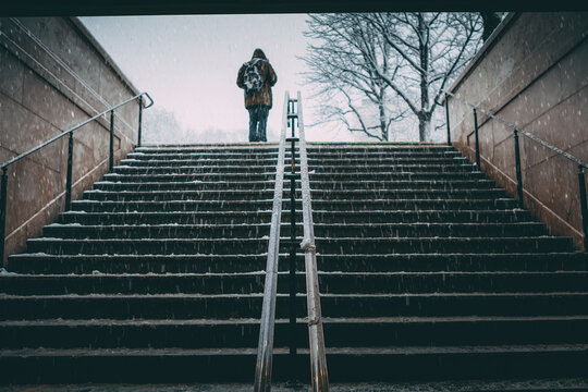 SIlhouette of a man going out of a metro station under heavy snow in Paris, France