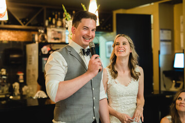 Bride and groom giving a speech during their reception