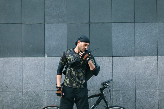 Bike Messenger on Walkie Talkie to Dispatcher