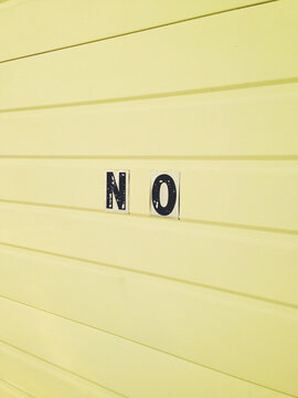 The word NO on yellow garage door, close up