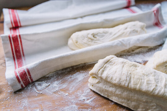 Sized ciabatta bread dough rising in a kitchen towel