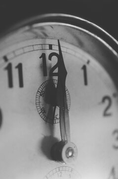 Black and white old clock at 12 o'clock