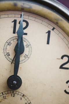 Close up of vintage clock at midday or midnight