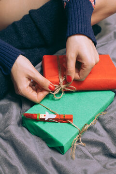 Female Hands Tied Christmas Gifts