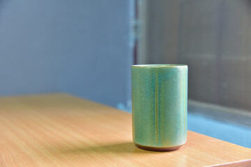 Vintage cup on wood table.