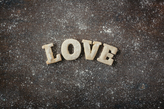 Shortbread Cookie Letters spelling out ""love"" and splattered with flour