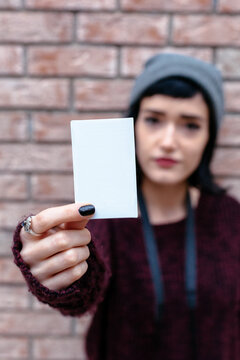 Woman holding a blank card