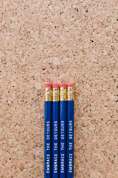 School pencils with stacked against a cork board background