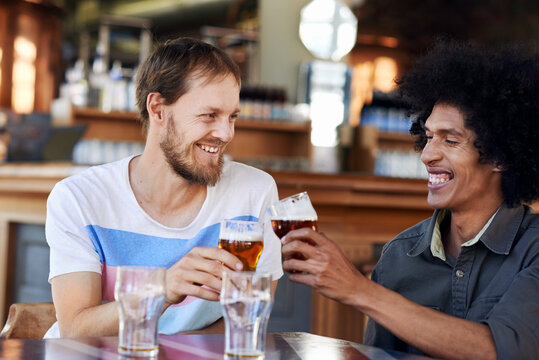 Friends cheers beer in pub