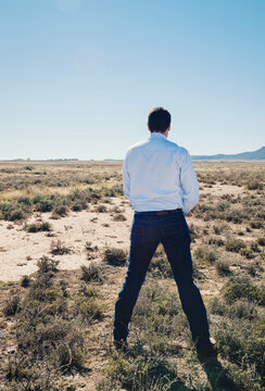 man peeing in the desert