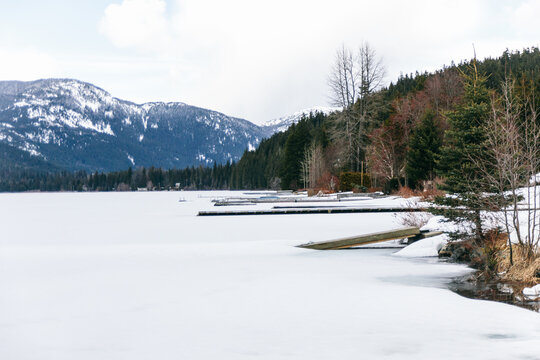 Frozen lake with docks and mountains