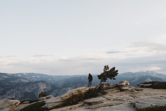 A woman walking on Sentinel Dome at sunrise