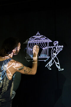 Artist drawing a wall with projector