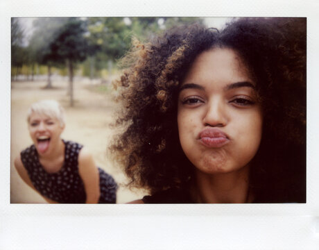 Self photo on polaroid of two joyful person