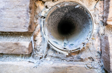 Interior view of dryer vent line with lint and dust buildup