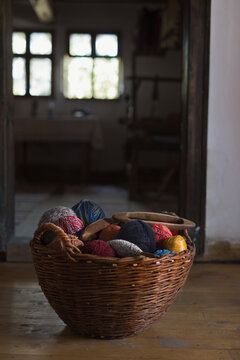 Wicker basket filled with colorful clews of wool