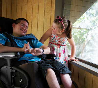 Little Girl and Young Man with a Disability