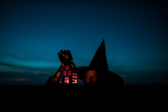 child with hat of halloween and light in the hands