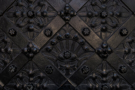 Ornaments on a black metal door