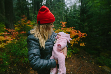 Young Mother Camping With 8 Week Old Baby In Autumnal Forest