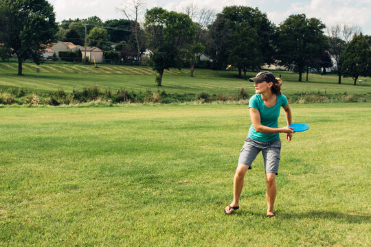 Female throwing a disc at a golf disc game