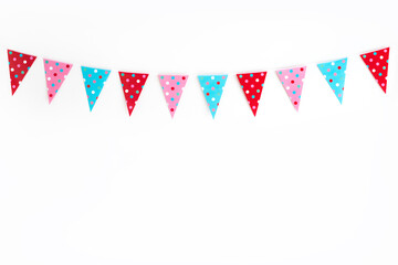 Party bunting against white wall with polka dots