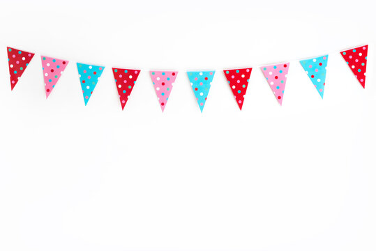 Party bunting against white wall with polka dots