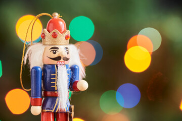 Traditional Christmas nutcracker with out of focus colored light background