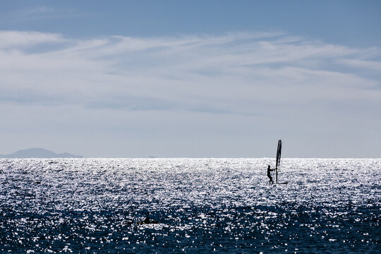 Unrecognizable man wind surfing in red sea