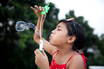 Teenage girl playing with bubble