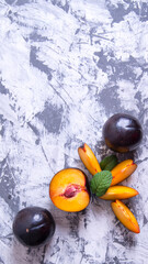 Plum whole and sliced,with the slices with mint leaves