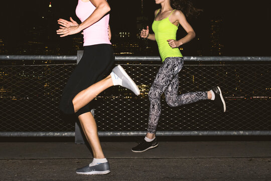 Young women jogging in New York City at night