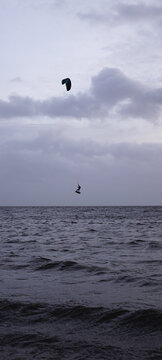 Jumping kitesurfer at sea